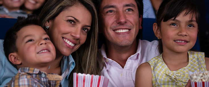 Family watching movie in a theater Family watching movie in a theater