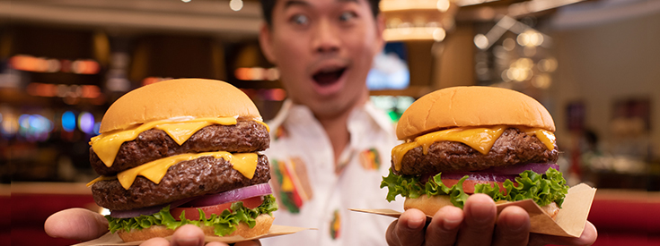 Man looking a two hamburgers Man looking a two hamburgers