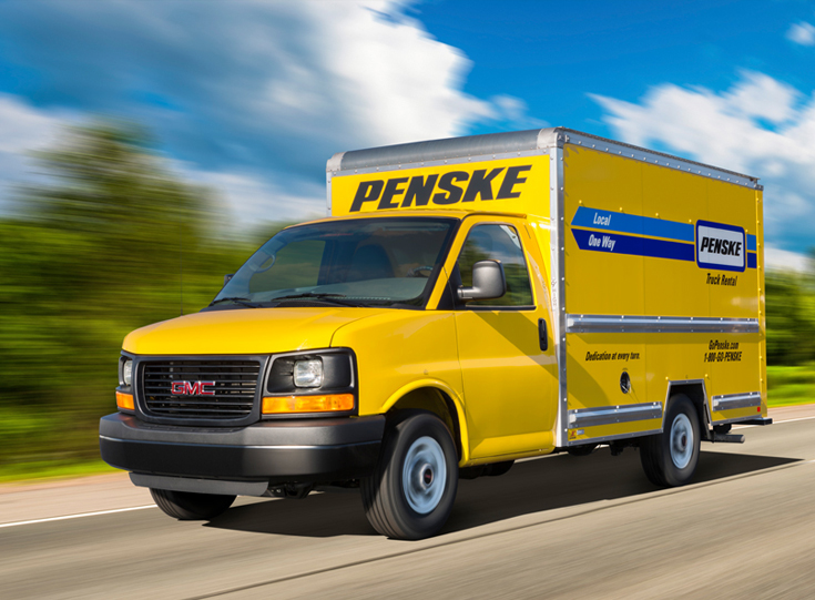 Penske moving truck driving on road Penske moving truck driving on road