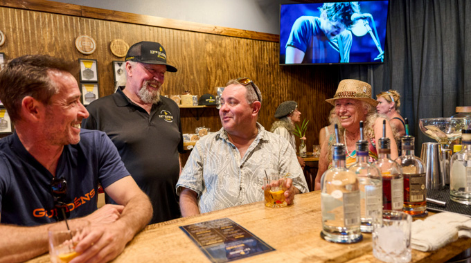 Dave Puckett, 12th Hawaii Distiller founder, talking with patrons at the bar.