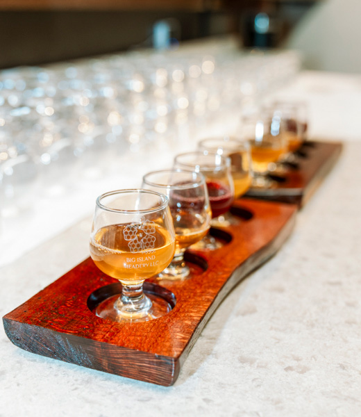 Wooden flight trays of honey wine samples at Big Island Meadery.