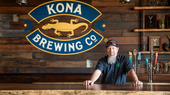 Ryan McVeigh standing behind the bar at Kona Brewing.