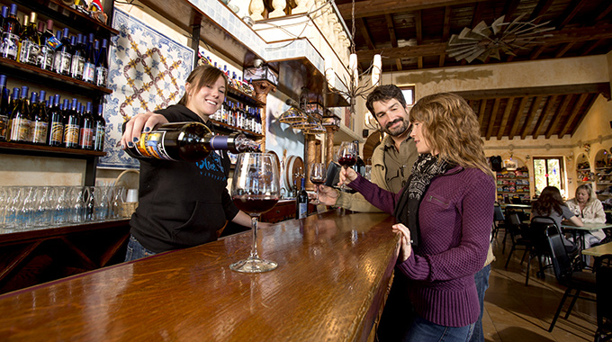 Blue Sky Vineyard employee pouring a red wine inside the tasting room.