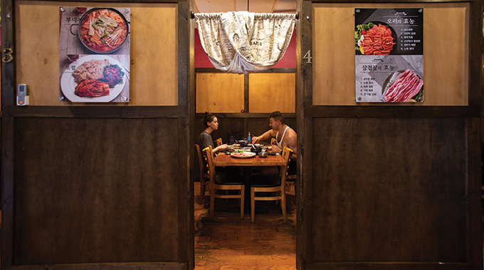 A pair of diners eat in a private stall at Kalim Korean BBQ