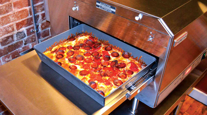 A pizza pan straight from the oven at Bangor Sandwich Co.