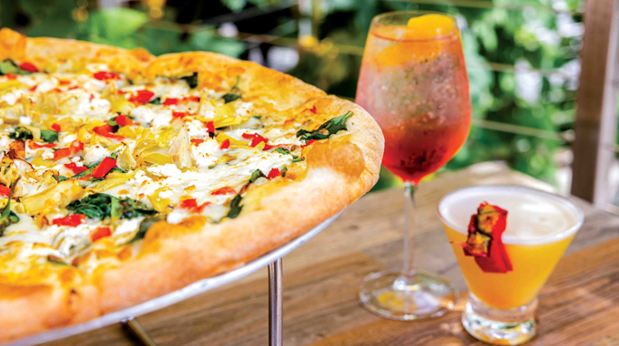 Piecasso Pizzeria & Lounge's Positive Pie, served alongside a pair of drinks