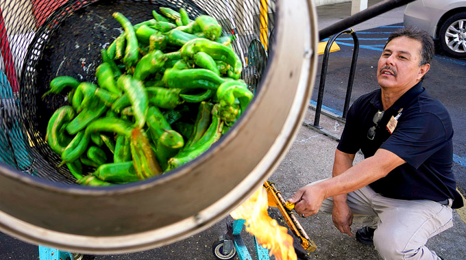 Man roasting green chiles