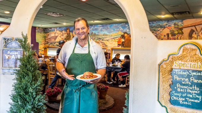 Waiter holding up a dish at Lorenzo's