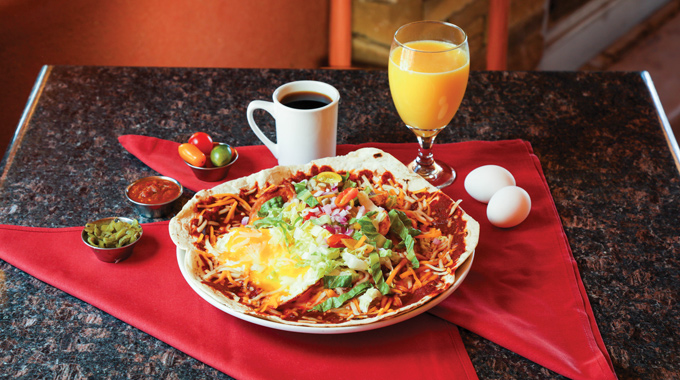 Rancheros de Albuquerque served with coffee and orange juice.