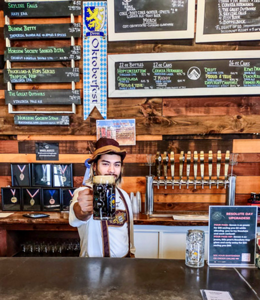Hernan Reyes raising a stein of beer