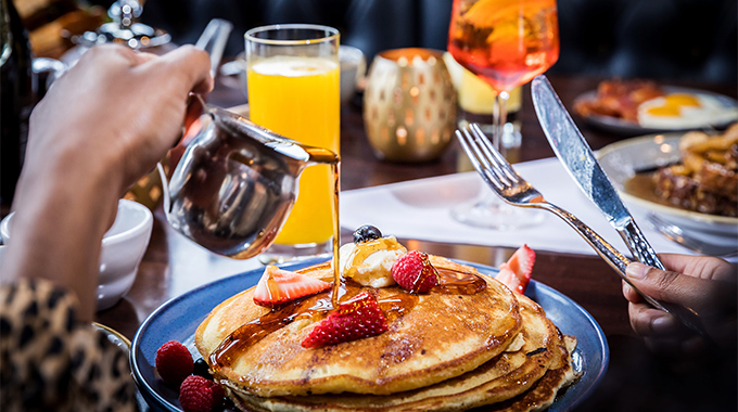 Fluffy pancakes and orange juice at Amici's Pizza Café in Suffolk. | Photo courtesy Dragon Studio