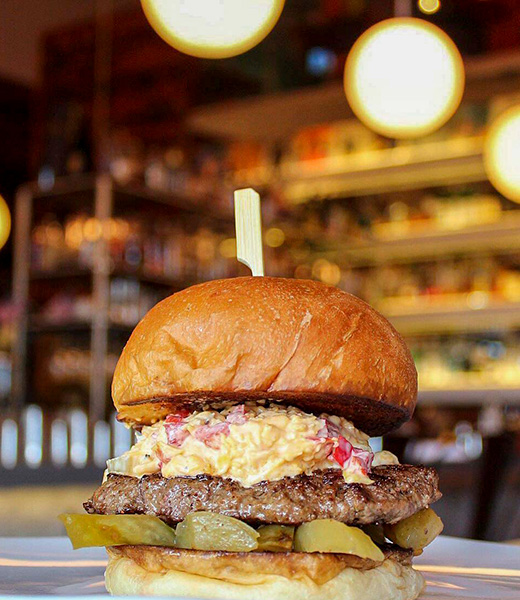 A burger from Big Orange with its signature spicy pimento cheese