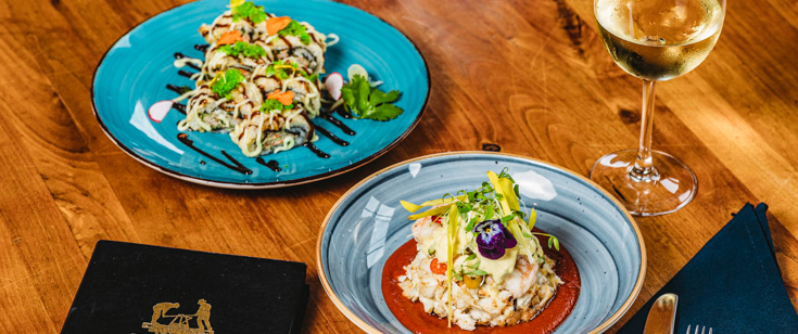 Food served with a glass of white wine. Food served with a glass of white wine.