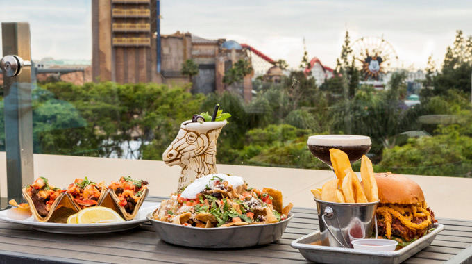 A pread of food at The Fifth Rooftop Restaurant & Bar, with Disneyland seen in the distance