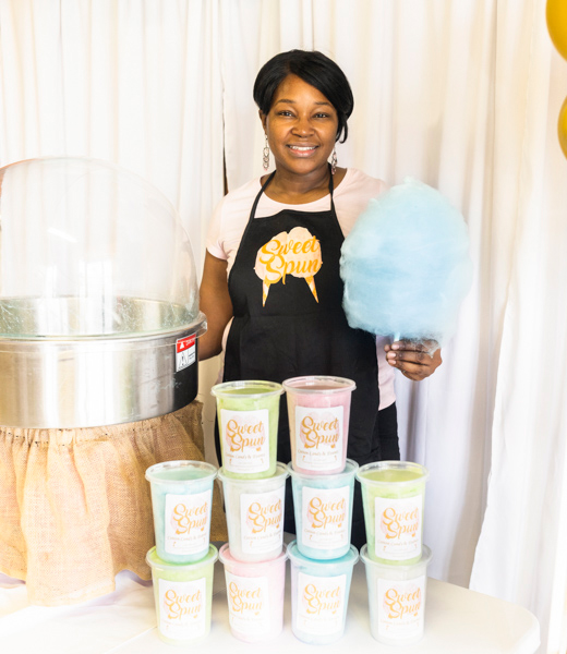 Kareemah Harvill holding a freshly spun cone of cotton candy