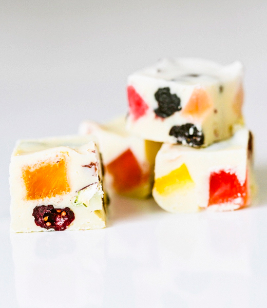 A cross section of chocolate bark showing fruit jellies inside