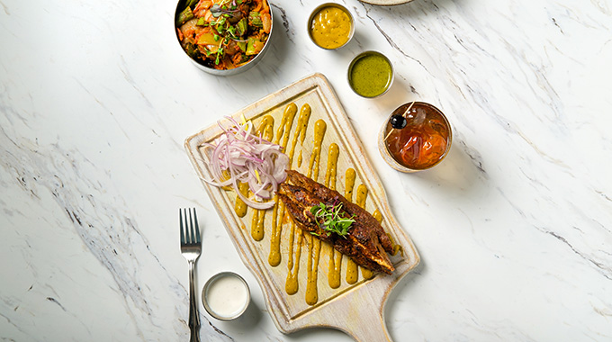 Lamb seekh kebabs served with side sauces