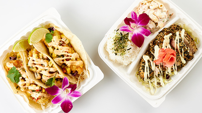 Takeout containers holding a trio of fish tacos and furikake-crusted ‘ahi with a side of rice