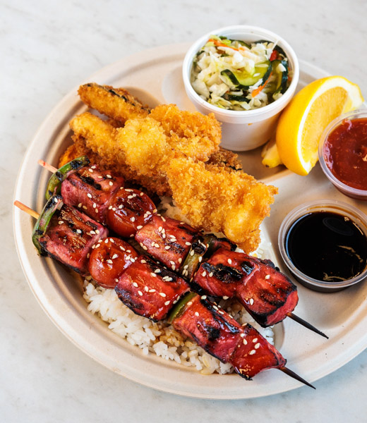 Skewers with teriyaki swordfish served on a bed of rice