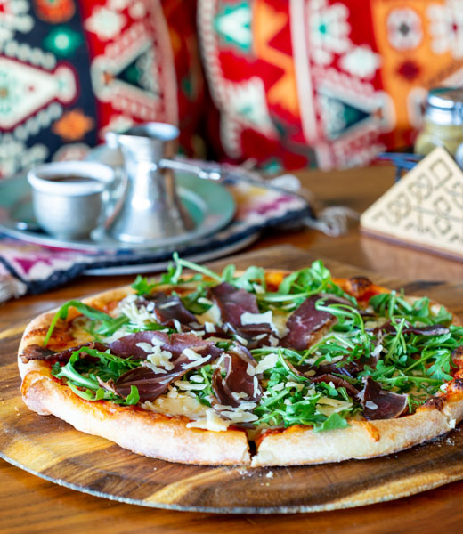 Sofra Urbana pizza topped with arugula and Suho Meso (Bosnian beef prosciutto)