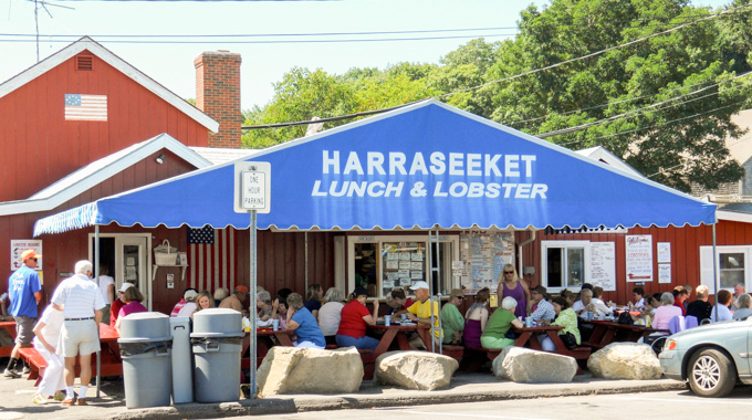 Diners fill the tables in front of Harraseeket Lunch and Lobster.