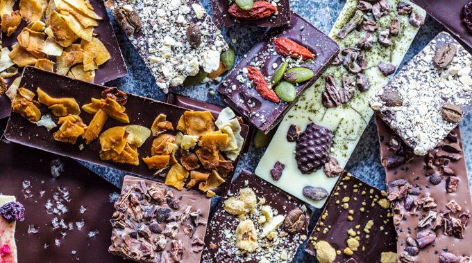 Chocolate bars embedded with various ingredients including nuts and dried fruit.