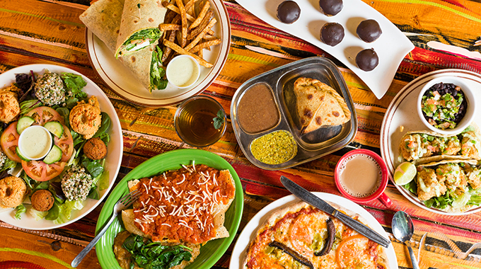 A table set with various dishes from Annapurna's World Vegetarian Café