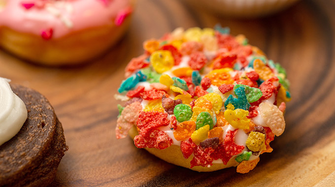 A doughnut topped with Fruity Pebbles