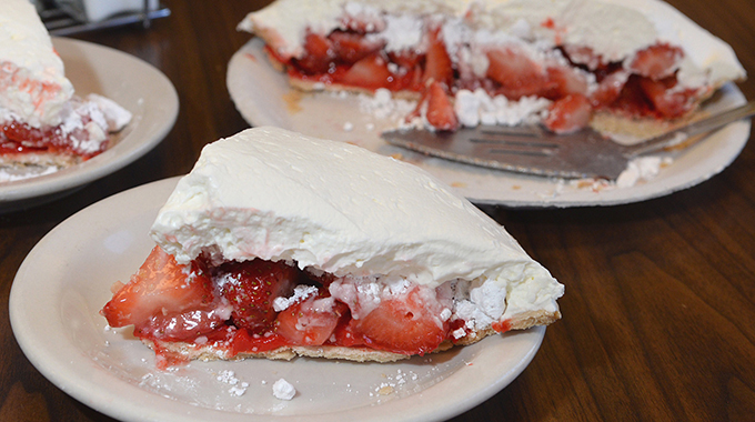 Plates with slices of strawberry pie