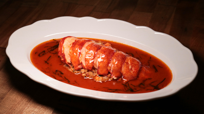 Lobster atop a bowl of basil bisque