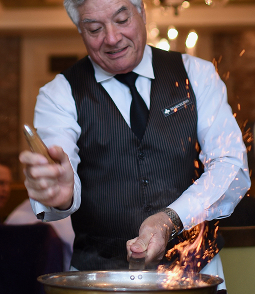 A waiter flambés bananas Foster at Brennan’s of Houston. | Photo by Kimberly Park