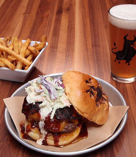 A burger, side of fries, and glass of beer