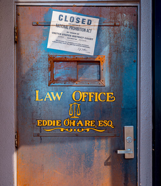 Prohibition door, painted with a notice of closure above the sign for "Law Office, Eddie O'Hare, Esq."