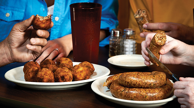 Diners share boudin at Hollier's Cajun Kitchen Boudin