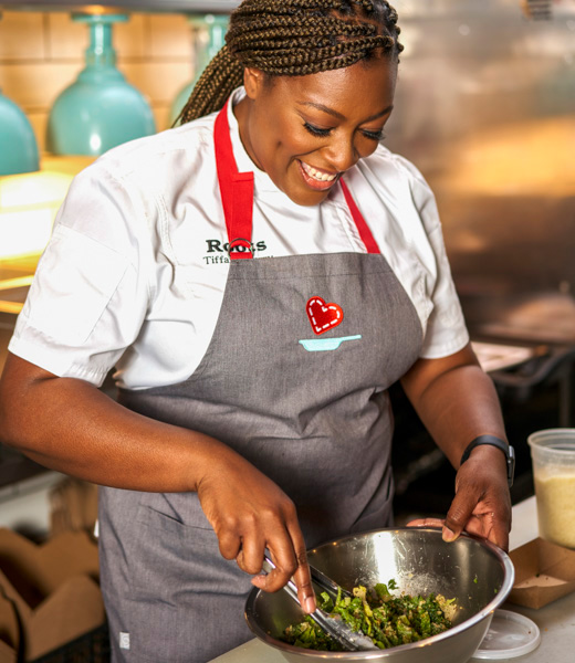 Tiffany Derry mixing ingredients in a metal bowl