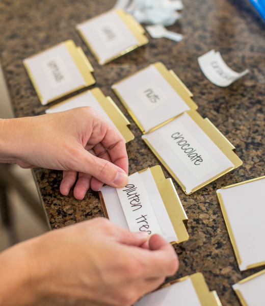 Printed labels marking "chocolate," "gluten," and other pantry categories 