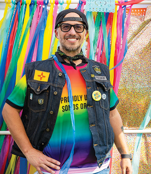 Jake Gutierrez, president of The Curse New Mexico, wearing a rainbow T-shirt