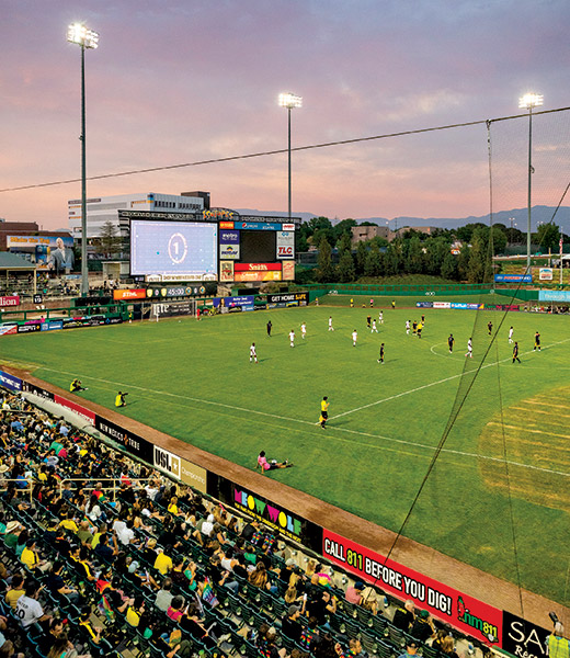 Players on the soccer pitch at Isotopes Park.
