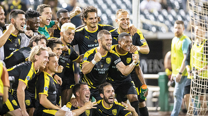 New Mexico United players pose for a photo after a game.