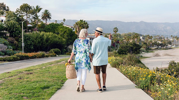 A couple takes a coastal stroll near Leadbetter Beach in Santa Barbara, CA. Photo Courtesy of @sbhotelgroup via Instagram. 