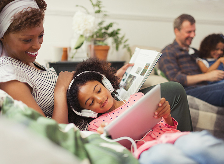 Mother and child reading on couch Mother and child reading on couch
