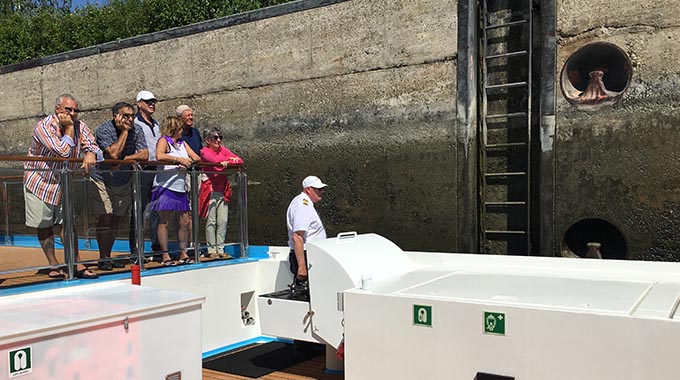 Cruisers watching as the captain navigates the AmaMagna through a lock on the Danube River