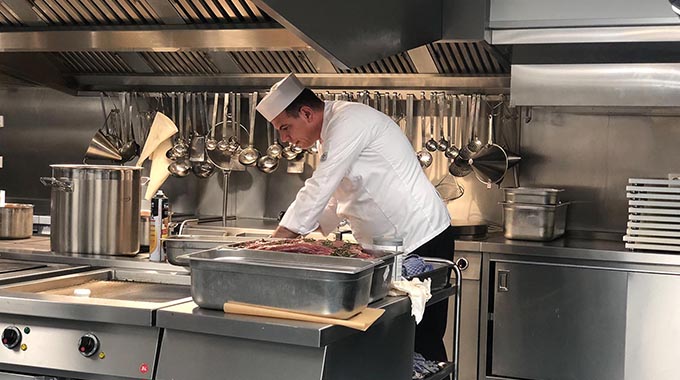 A chef prepping food in the AmaMagna kitchen