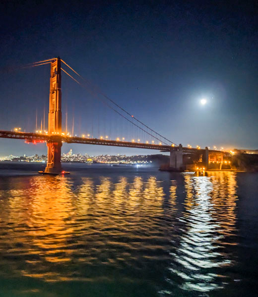 Golden Gate Bridge seen from the water at night