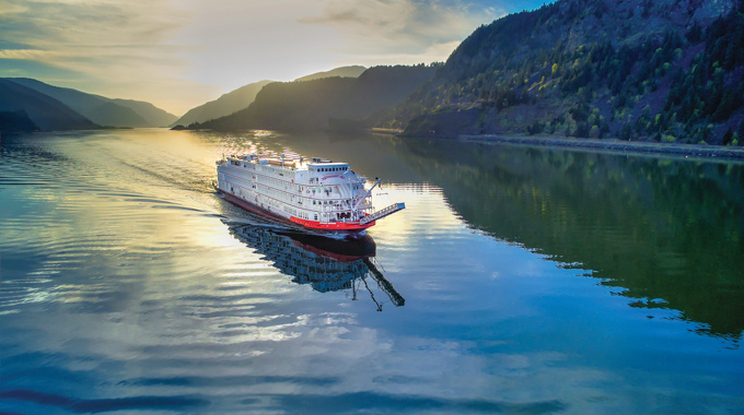 American Queen steamboat floating down a river