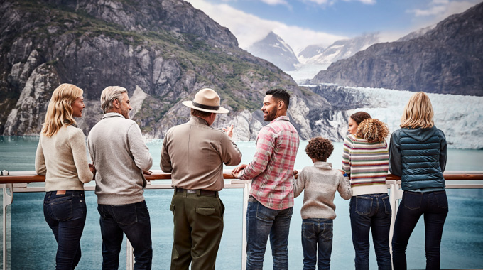 A  park ranger talking with cruise passengers as they look out toward Glacier Bay