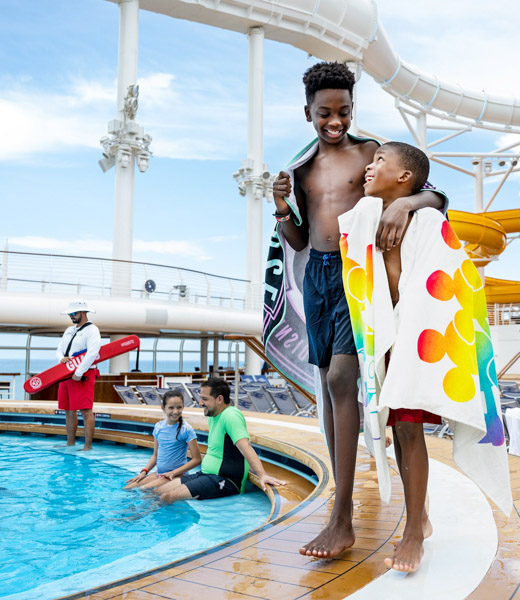 Cruisers enjoying the pool on the upper deck of the Disney Wish