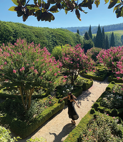 A woman twirling in the Mateus Palace Topiary Garden