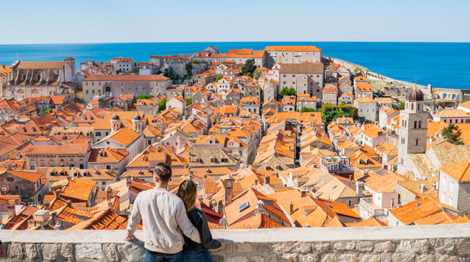 Couple overlooking the cityscape from Fort Lovrijenac in Dubrovnik, Croatia
