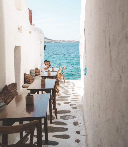 Couple dining seaside in Mykonos